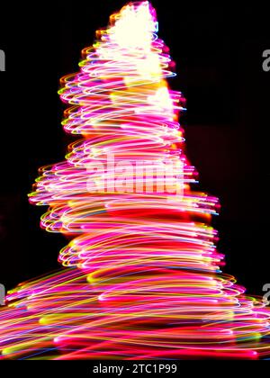 Long exposure light trails of pink, orange, yellow and blue light Stock Photo