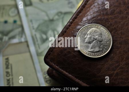 US Quarter dollar is stacked under United States geographical map with wallet Stock Photo