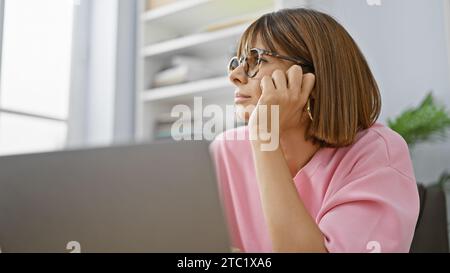 Thoughtful young professional, beautiful hispanic woman worker deep in thought at the office, looking to the side, working hard towards success at her Stock Photo