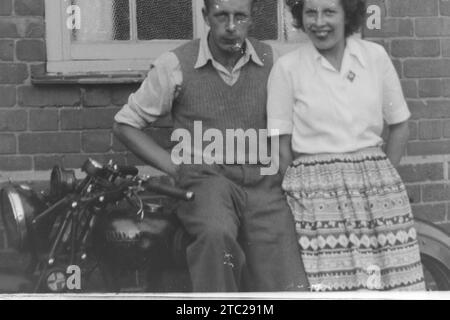 Archive photograph of a young man and woman posing in front of a 'Rudge Special' motorcycle, circa 1930, England Stock Photo