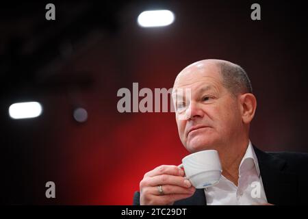 Berlin, Germany. 10th Dec, 2023. Federal Chancellor Olaf Scholz (SPD) sits at the SPD's regular federal party conference at the Berlin Exhibition Center. Chancellor Scholz (SPD), Vice Chancellor Habeck (Greens) and Finance Minister Lindner (FDP) have been wrestling for days over how to plug a 17 billion euro hole in the budget for 2024. Negotiations are set to continue this evening. Credit: Bernd von Jutrczenka/dpa/Alamy Live News Stock Photo