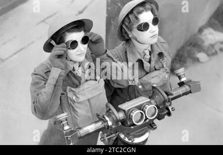 Women of the Auxiliary Territorial Service (ATS) take cover in a trench ...
