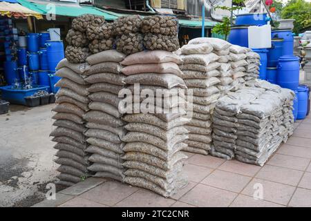 Stack of gravel bags sold at a garden store, pebbles for garden decoration. Stones of various fractions and mineral origins for landscaping. Stock Photo