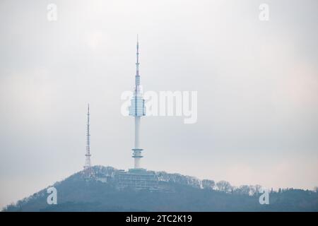 N Seoul Tower in cloudy sky. It is the landmark which is a communication and observation tower located on Nam Mountain in central Seoul, South Korea Stock Photo