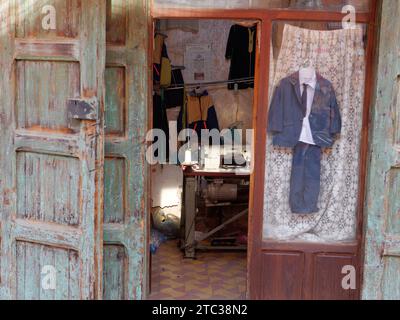 Traitional sewing shop in Marrakesh aka Marrakech with Mosque in the distance, Morocco, December 10, 2023 Stock Photo