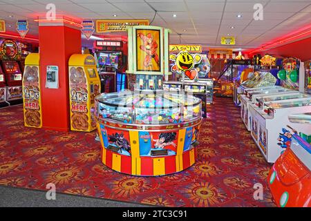 Amusement Arcade entrance early morning seaside resort colourful interior slot machines gambling business premises bright colours Norfolk England UK Stock Photo