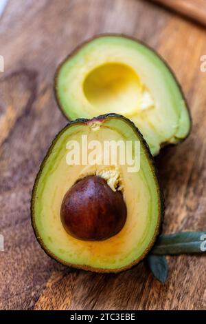 Close-up of a fresh and healthy avocado cut in half with pit, copy space Stock Photo