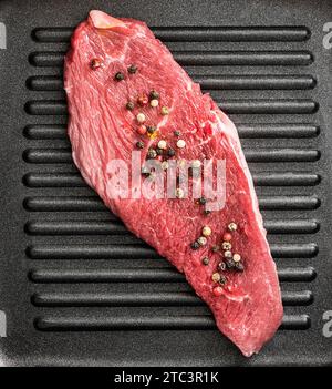 piece of raw beef in a pan Stock Photo