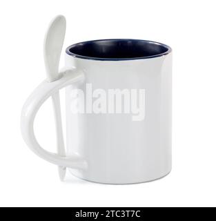 White cup with colored mid with white teaspoon isolated on a white background Stock Photo