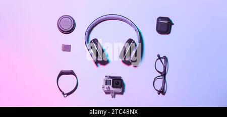 Different modern gadgets and eyeglasses on lilac background Stock Photo