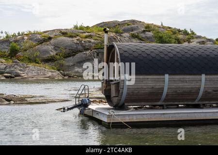 Gothenburg, Sweden - July 24 2022: Barrel shaped sauna placed on a wooden raft. Stock Photo