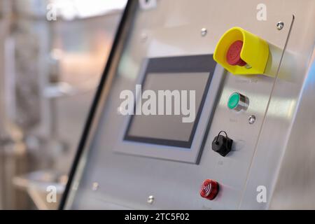 Modern industrial touchscreen control panel. Stainless steel control console in pharmaceutical or food factory. Selective focus. Stock Photo