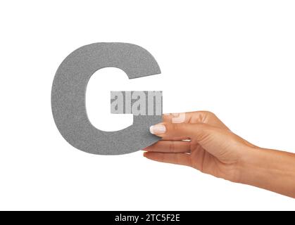 Hand of woman, capital letter G and presentation of consonant isolated on white background. Character, font and person with English alphabet typeface Stock Photo