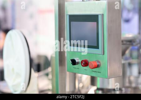 Industrial stainless steel control console with touch screen in pharmaceutical factory. Selective focus. Stock Photo