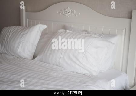 white pillow lined up on bed  Stock Photo