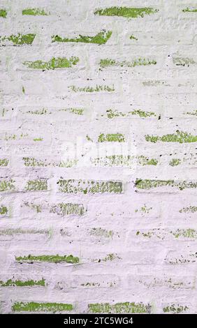 Front View of Grunge Painted White and Green Brick Wall Stock Photo