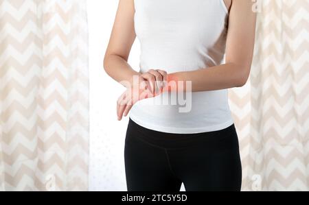 Woman with carpal tunnel syndrome is touching her sore wrist Stock Photo