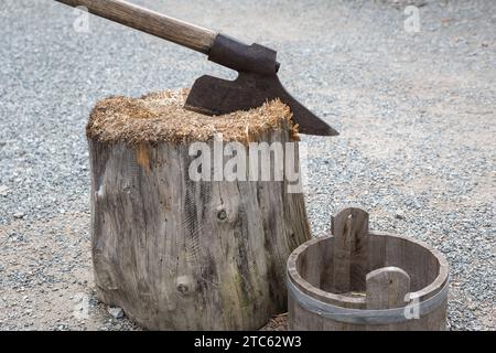 A hangman's ax stuck in a wooden trunk. Stock Photo