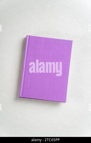 Purple closed notebook on gray background. View from above Stock Photo
