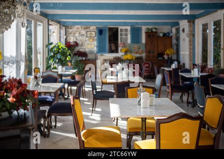 Cozy restaurant with luxury comfortable atmosphere, elegant armchairs, refined chandeliers, plants Stock Photo