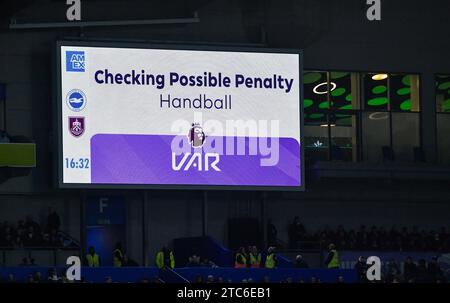 A VAR penalty check during the Premier League match between Brighton and Hove Albion and Burnley at the American Express Stadium  , Brighton , UK - 9th December 2023 Photo Simon Dack / Telephoto Images Editorial use only. No merchandising. For Football images FA and Premier League restrictions apply inc. no internet/mobile usage without FAPL license - for details contact Football Dataco Stock Photo