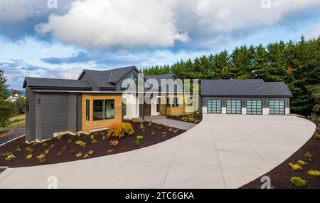 Three car garage exterior with stone veneer and green board and batten ...