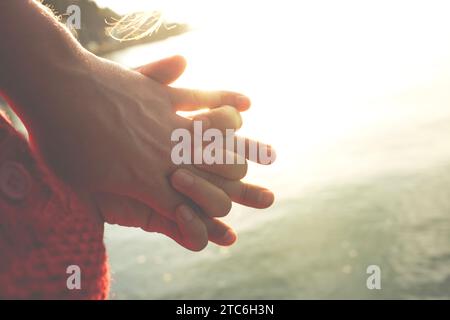 gesture of two people holding hands, concept of friendship and love Stock Photo