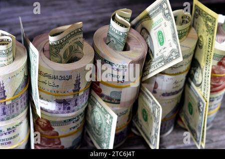 Piles and bundles of Egypt money  thousands of Pounds currency banknotes bills rolls of 200 EGP LE, Egyptian money exchange rate and USA American doll Stock Photo