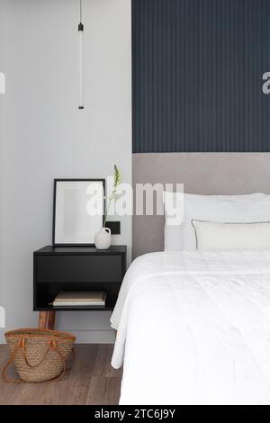 Soft bed headboard and decorated bedside table Stock Photo