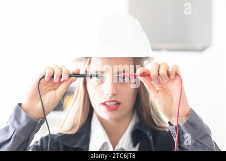 Young engineer female with helmet in a work shop Stock Photo