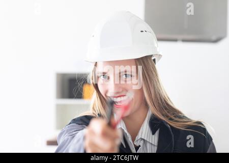 Young engineer female with helmet in a work shop Stock Photo
