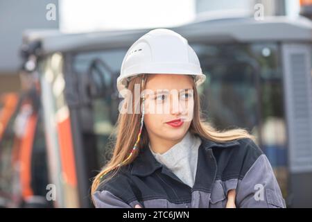 Young engineer female with helmet watching Stock Photo