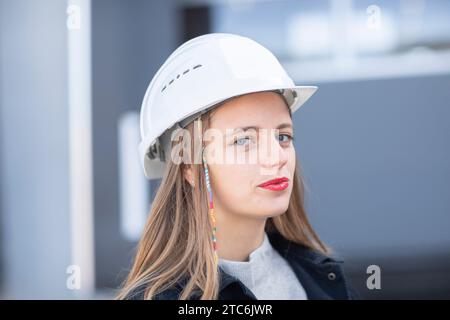 Young engineer female with helmet watching Stock Photo