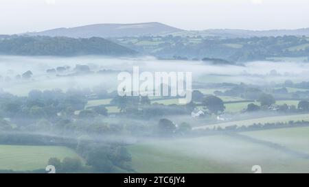 Mist shrouded rolling countryside near Chagford in Dartmoor National Park, Devon, England.  Autumn (September) 2023. Stock Photo
