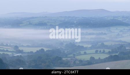 Mist shrouded rolling countryside near Chagford in Dartmoor National Park, Devon, England.  Autumn (September) 2023. Stock Photo