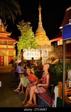 Two Foreign Women enjoying evening at Walking Street Night Market Old City Chiang Mai Thailand Stock Photo