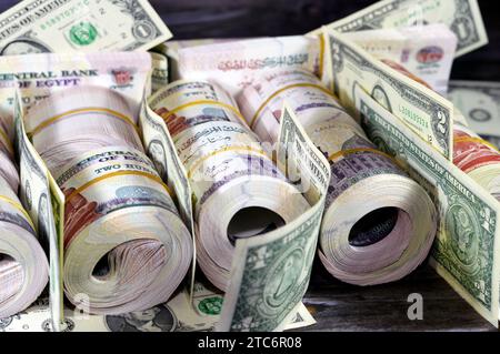 Piles and bundles of Egypt money  thousands of Pounds currency banknotes bills rolls of 200 EGP LE, Egyptian money exchange rate and USA American doll Stock Photo