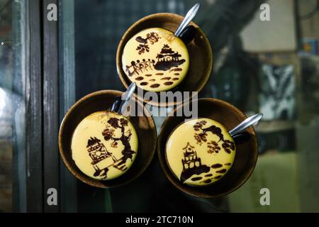 (231211) -- BEIJING, Dec. 11, 2023 (Xinhua) -- This photo taken on July 22, 2023 shows egg coffee with patterns of Hanoi's landscape at a coffee shop in the Old Quarter in Hanoi, capital of Vietnam.  The Vietnamese capital city of Hanoi, located on the Red River Delta, is an ancient city with a history of more than a thousand years. With natural scenery and subtropical city view, it draws lots of visitors from home and abroad. (Photo by Pham Dinh Duc/Xinhua) Stock Photo