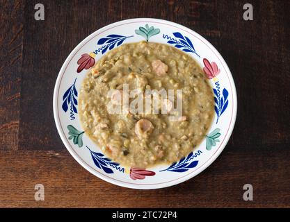 Thick dutch pea soup with smoked sausage and bacon called Snert Stock Photo