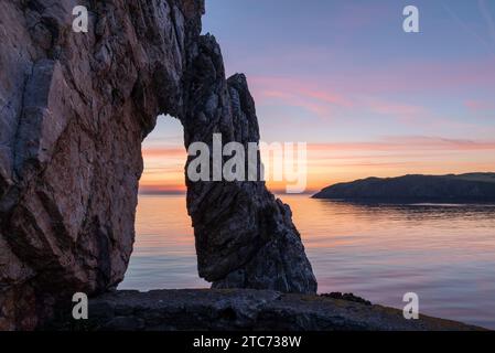 Rock arch at the Victorian brickworks site at Porth Wen, Anglesey, Wales, UK.  Spring (May) 2019. Stock Photo