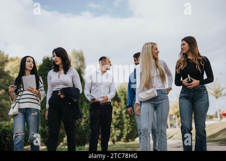 University Colleagues Share Knowledge and Prepare for Exams in a Sunny Park Stock Photo