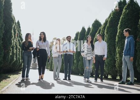 Group of University Students Collaborating on a Project in a Sunny Park Stock Photo
