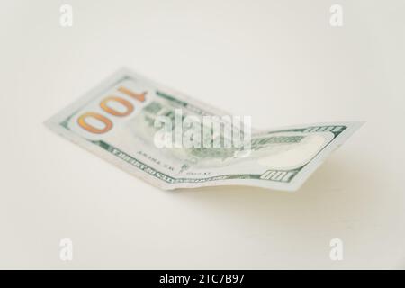 100 dollars on old white wooden table Stock Photo