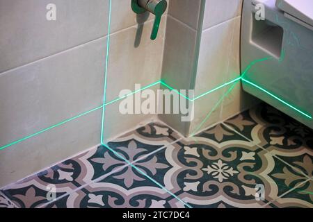 Laser level measuring tool in construction site for laying tiles Stock Photo