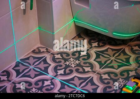 Laser level measuring tool in construction site for laying tiles Stock Photo