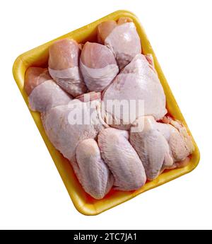 Raw chicken legs, thighs and wings in a plastic tray isolated Stock Photo
