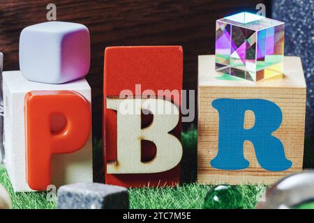 Abbrev PBR  spelled in various letters among different objects. Physically Based Rendering concept photography Stock Photo