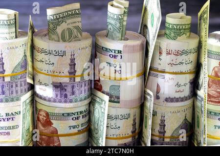 Piles and bundles of Egypt money  thousands of Pounds currency banknotes bills rolls of 200 EGP LE, Egyptian money exchange rate and USA American doll Stock Photo