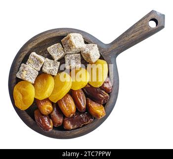 Turkish delight, dried apricots and dates on wooden platter isolated above Stock Photo