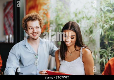 A collaborative architectural team discussing paperwork, project planning, and finances. Stock Photo